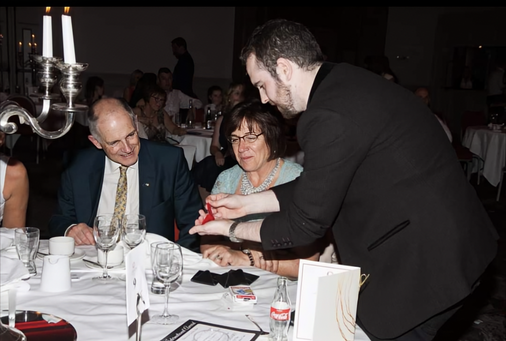 David Peace performing close up at a banquet table