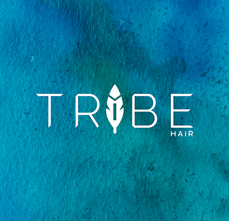 Logo for Tribe Hair featuring a feather design between the words 'Tribe' and 'Hair' on a textured blue background.