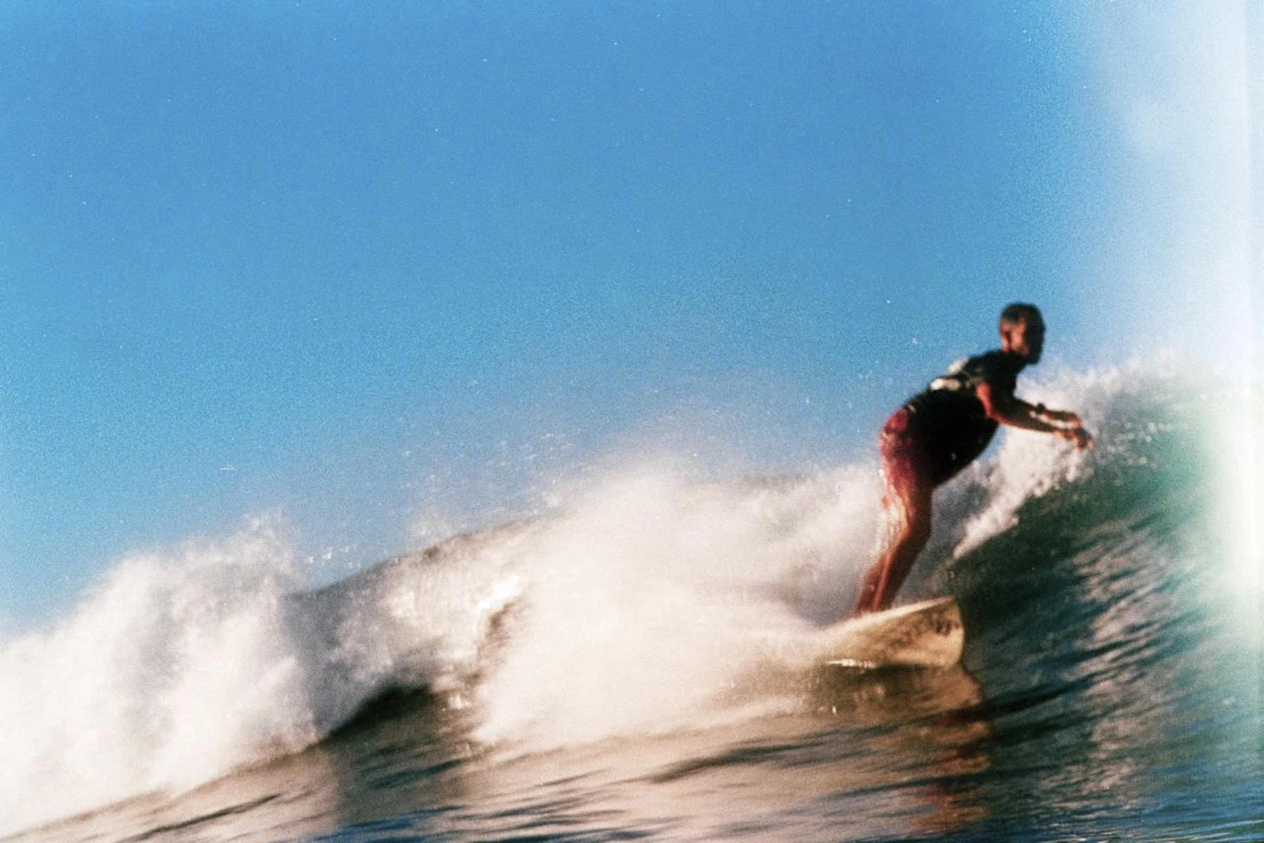 ISA-certified coach surfing wave at Playa Guiones Nosara, Costa Rica
