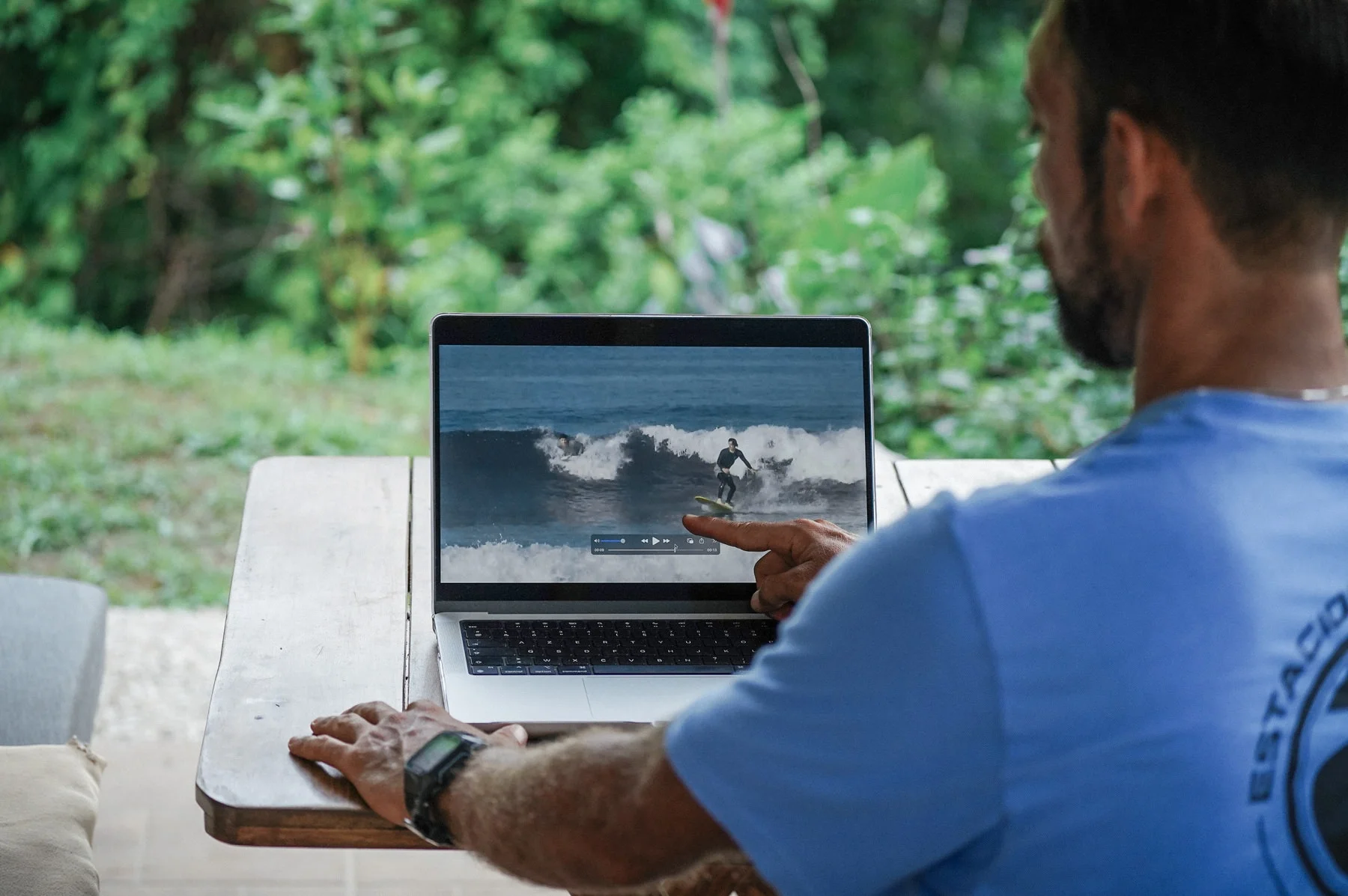 Surf coach pointing out technique during a video analysis session in Costa Rica