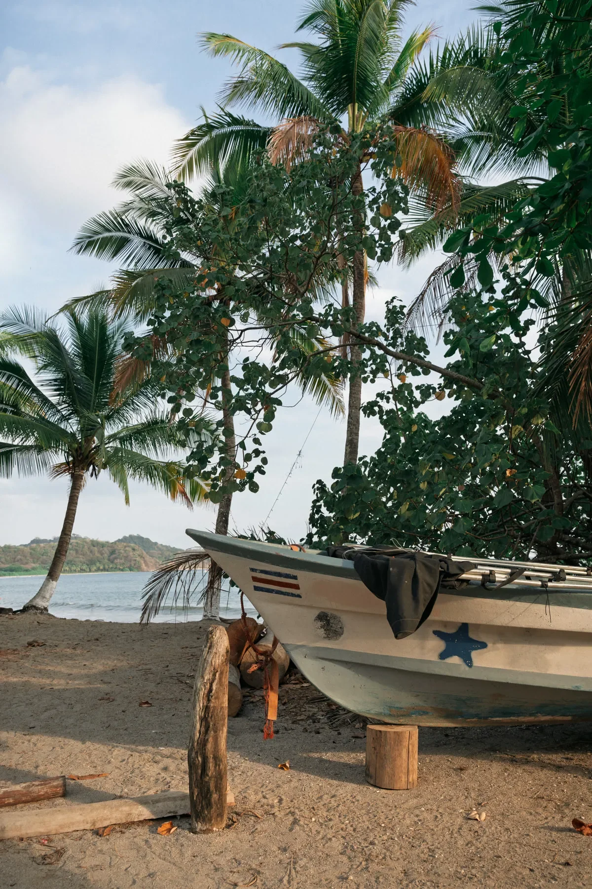 Fishing boat on the sand and palm trees in background at Playa Garza, Costa Rica