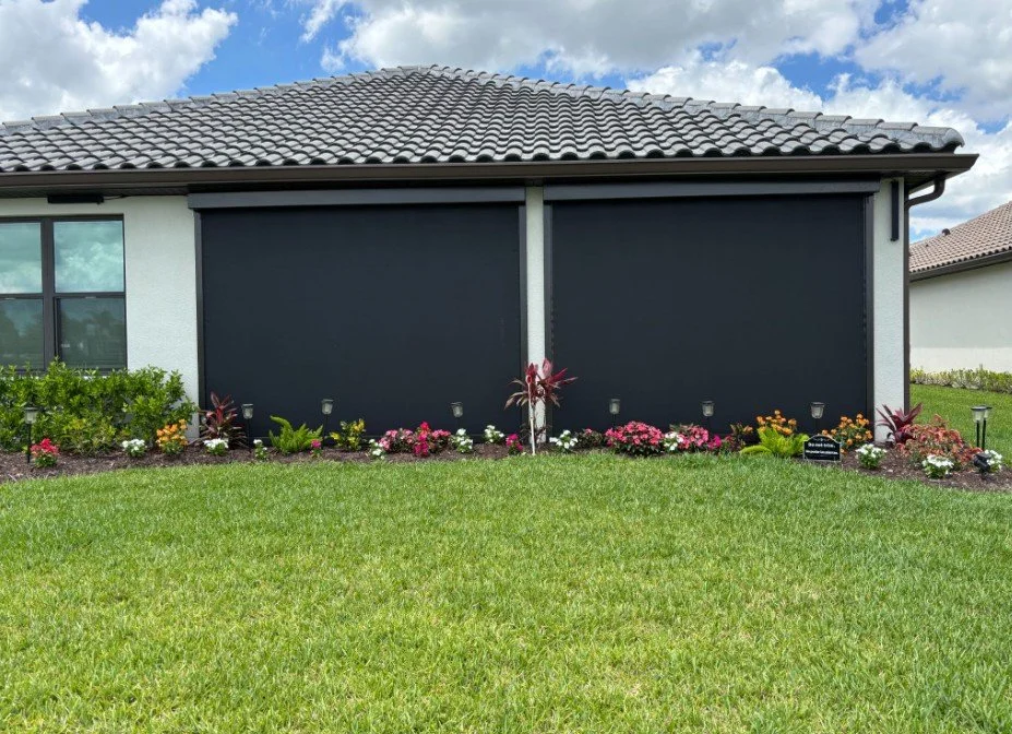UltraShield hurricane screens closed across the lanai of a tile-roof home, installed by Expert Shutter Services, serving Palm City, FL
