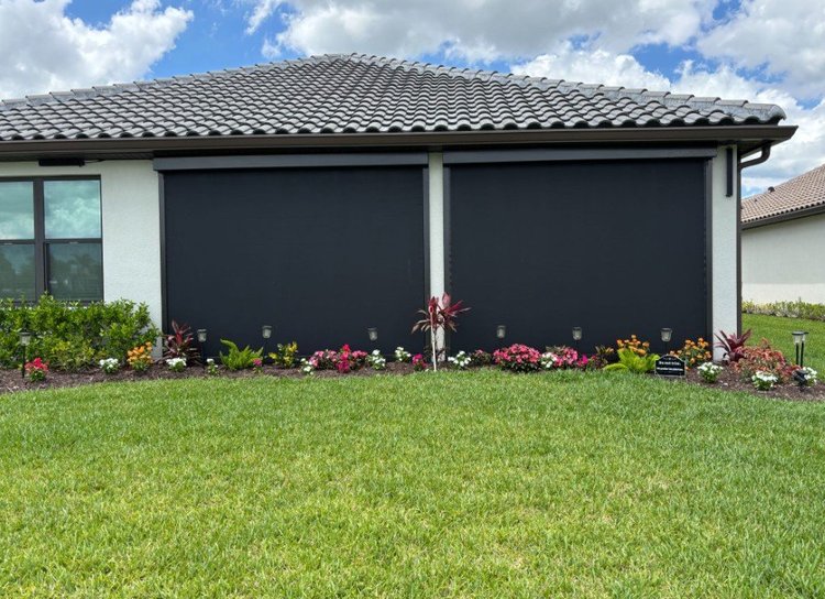 UltraShield hurricane screens closed across the lanai of a tile-roof home, installed by Expert Shutter Services, serving Vero Beach, FL