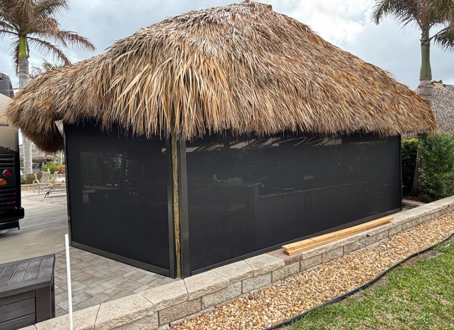 UltraShield screens installed around a backyard tiki hut, installed by Expert Shutter Services, serving Fort Pierce, FL