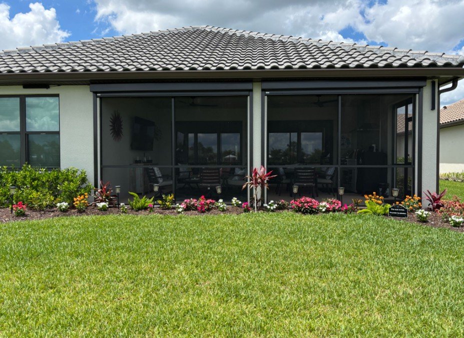 Motorized UltraShield screens partially open on a lanai, installed by Expert Shutter Services, serving Fort Pierce, FL