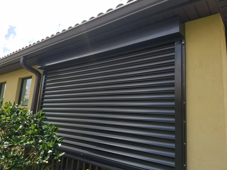 Nautilus rolling hurricane shutter closed over a window, installed by Expert Shutter Services, serving Palm City, FL