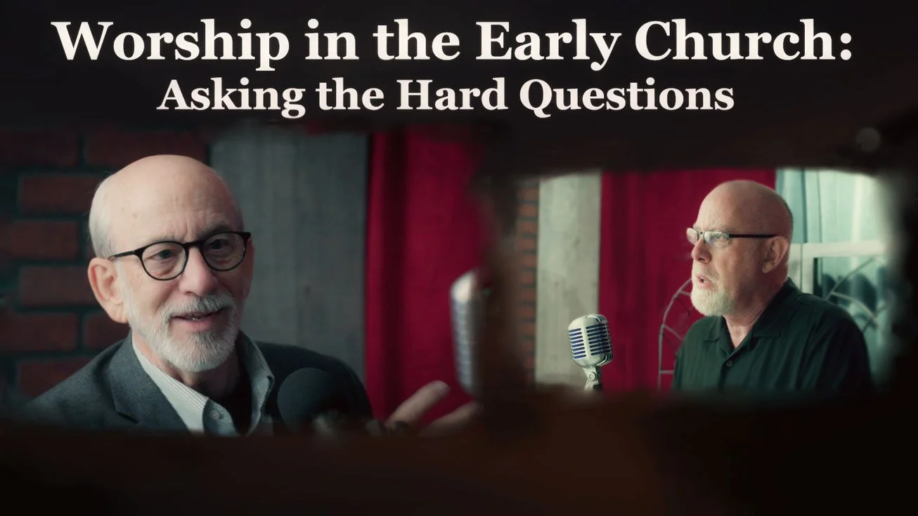 Tom Wadsworth and Shane Irwin discussing with the text "Worship in the Early Church: Asking the Hard Questions"