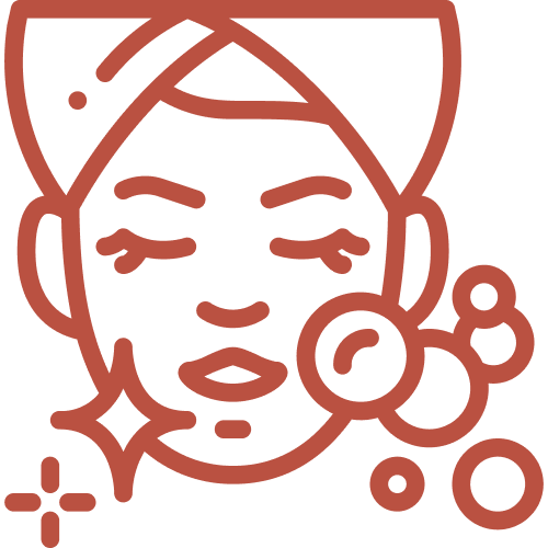 A woman receiving a facial treatment and head spa combo