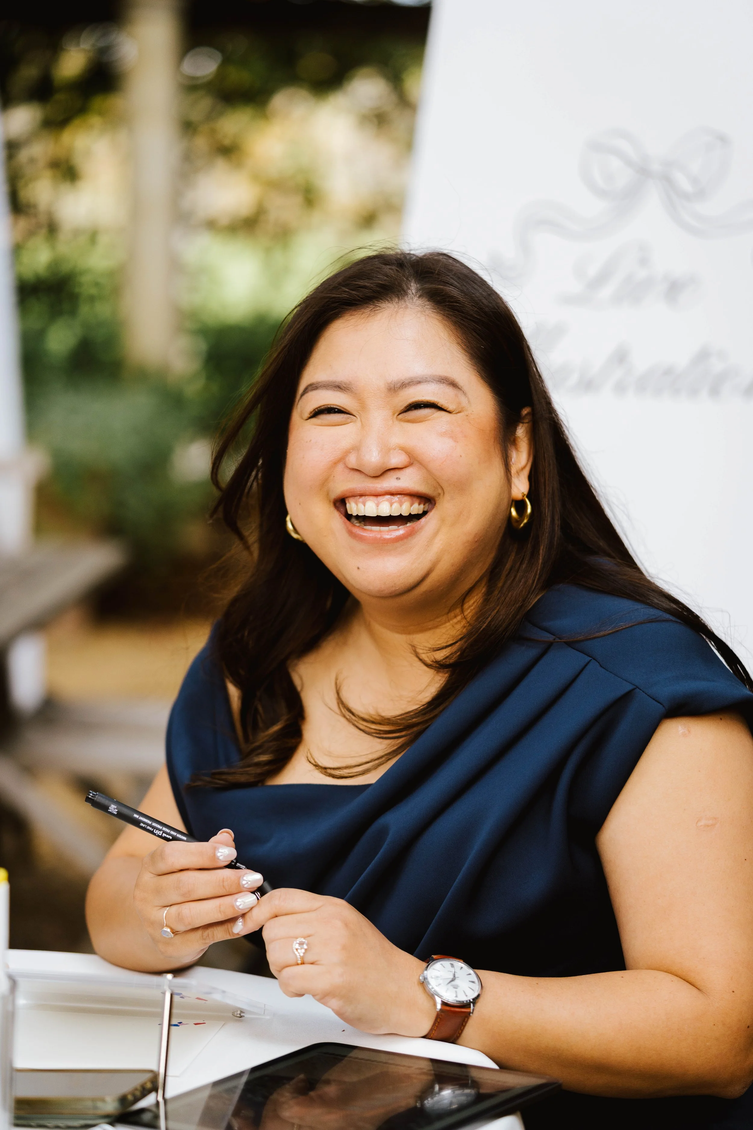 Live wedding illustrator sketching guest portraits in real time during a celebration.