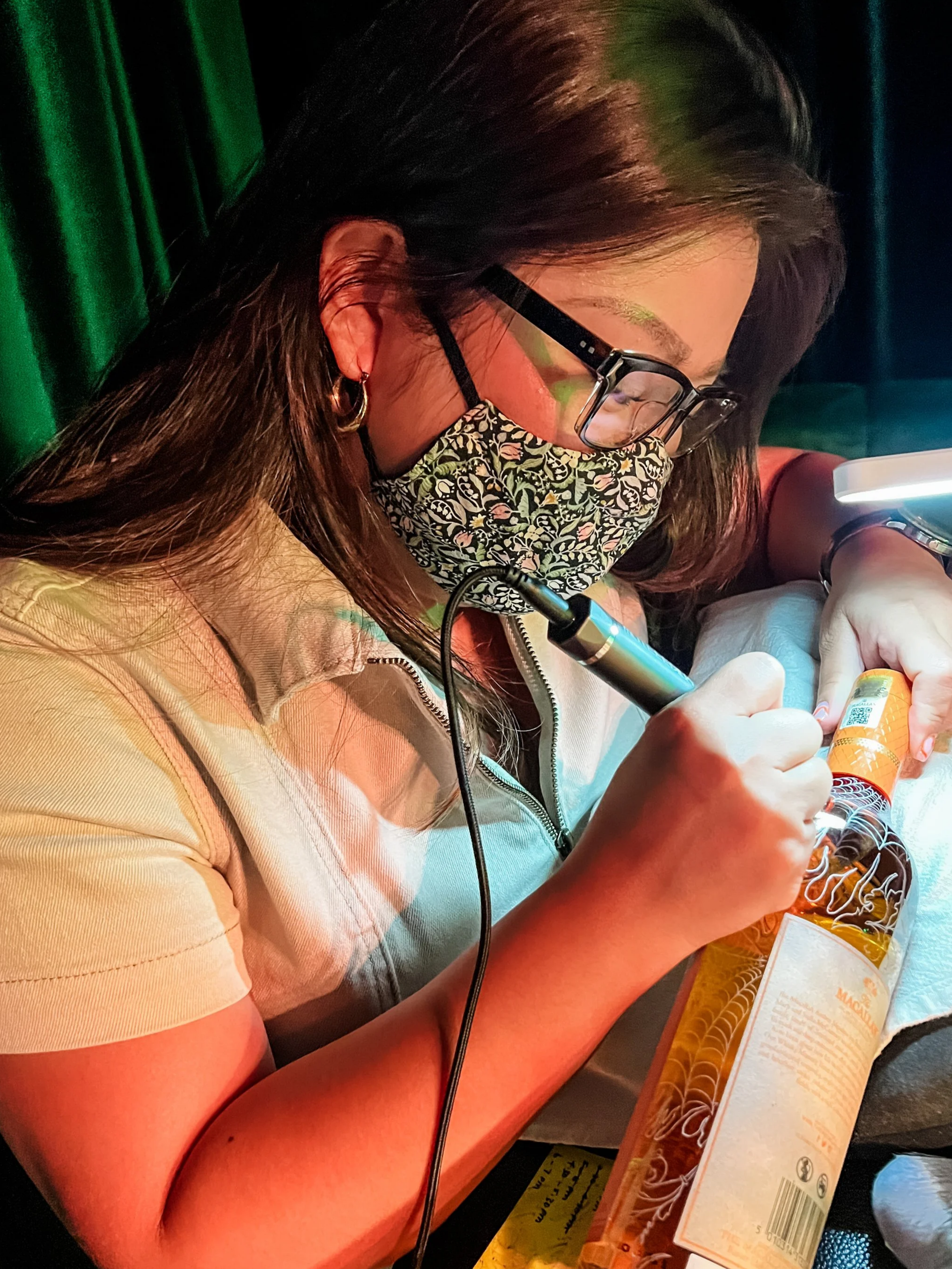 Sydney calligrapher performing live calligraphy engraving on Macallan whiskey bottle at a luxury product launch in Sydney