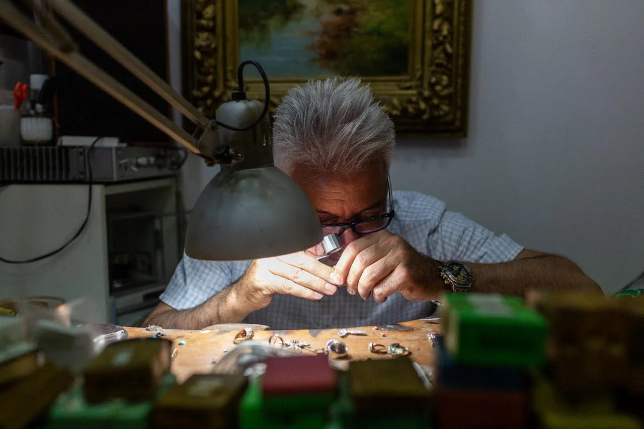 A jewler in the Grand Bazaar analyses their work