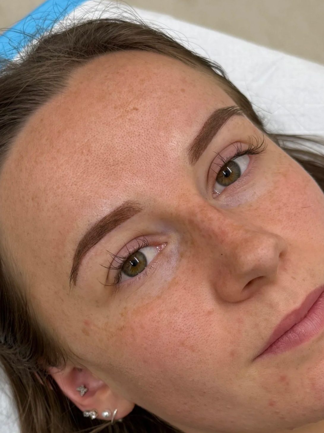 Close-up of a person's face partially shadowed, with light illuminating one eye.