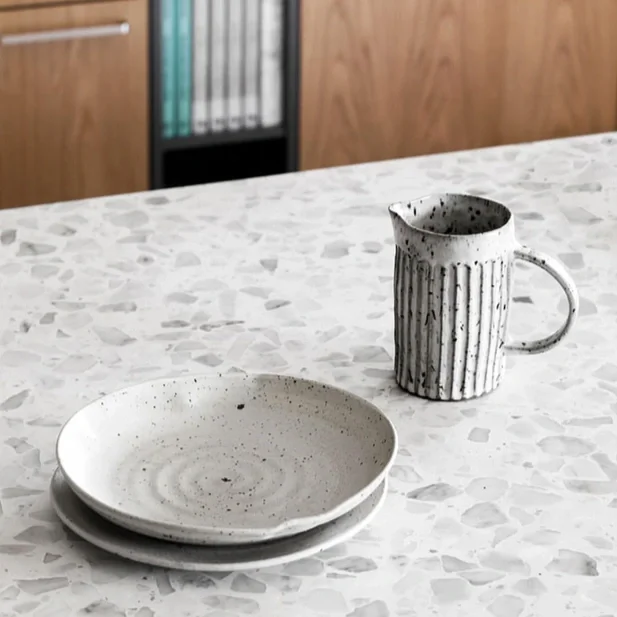 Coffee cup and saucer on terrazzo table top