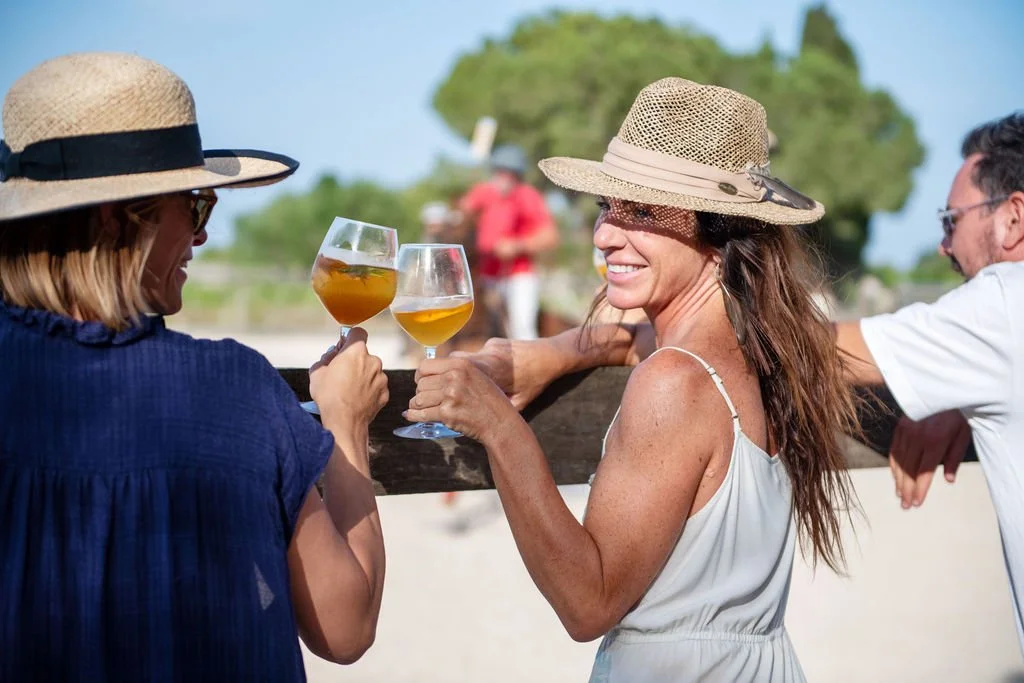 Women drinking Amargero Spritz in front of polo match in Mallorca