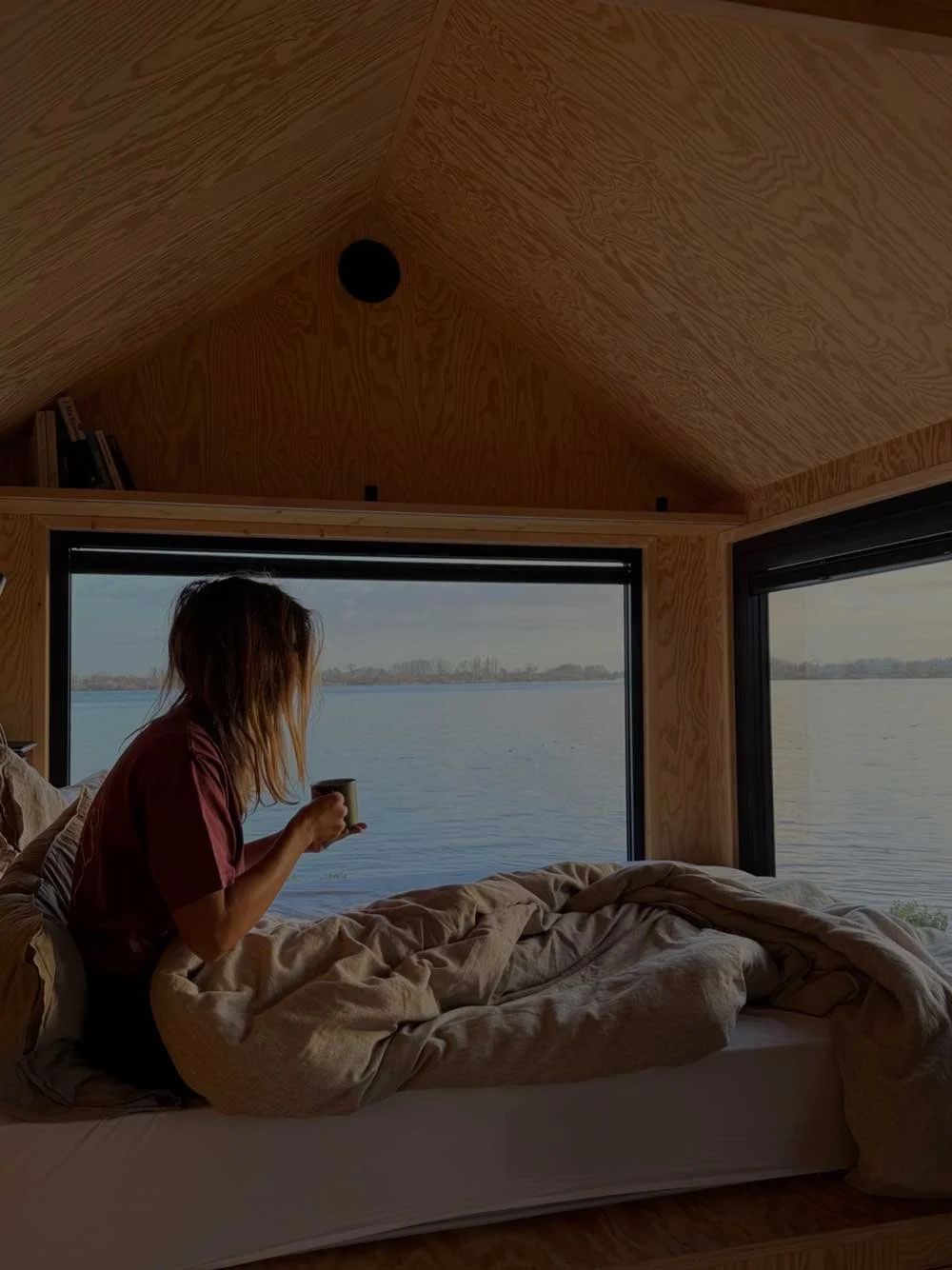 TerraCabins - Girl on bed drinking coffee.jpg