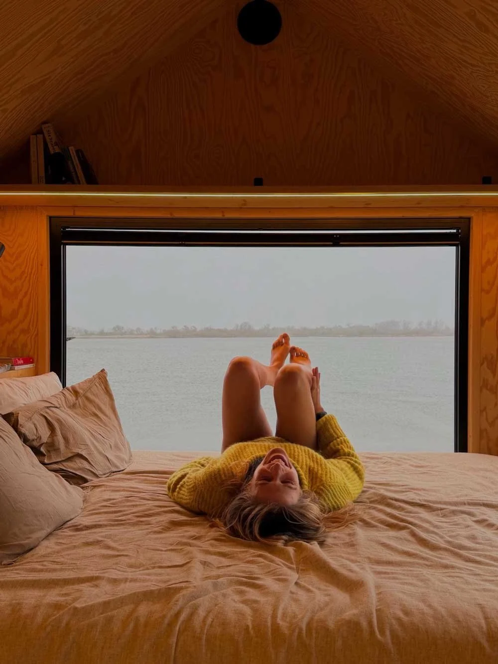 TerraCabins - Girl on bed laughing.jpg