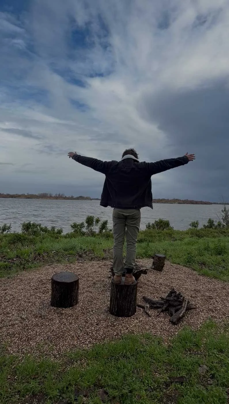 TerraCabins - Man standing on a wooden log.jpg