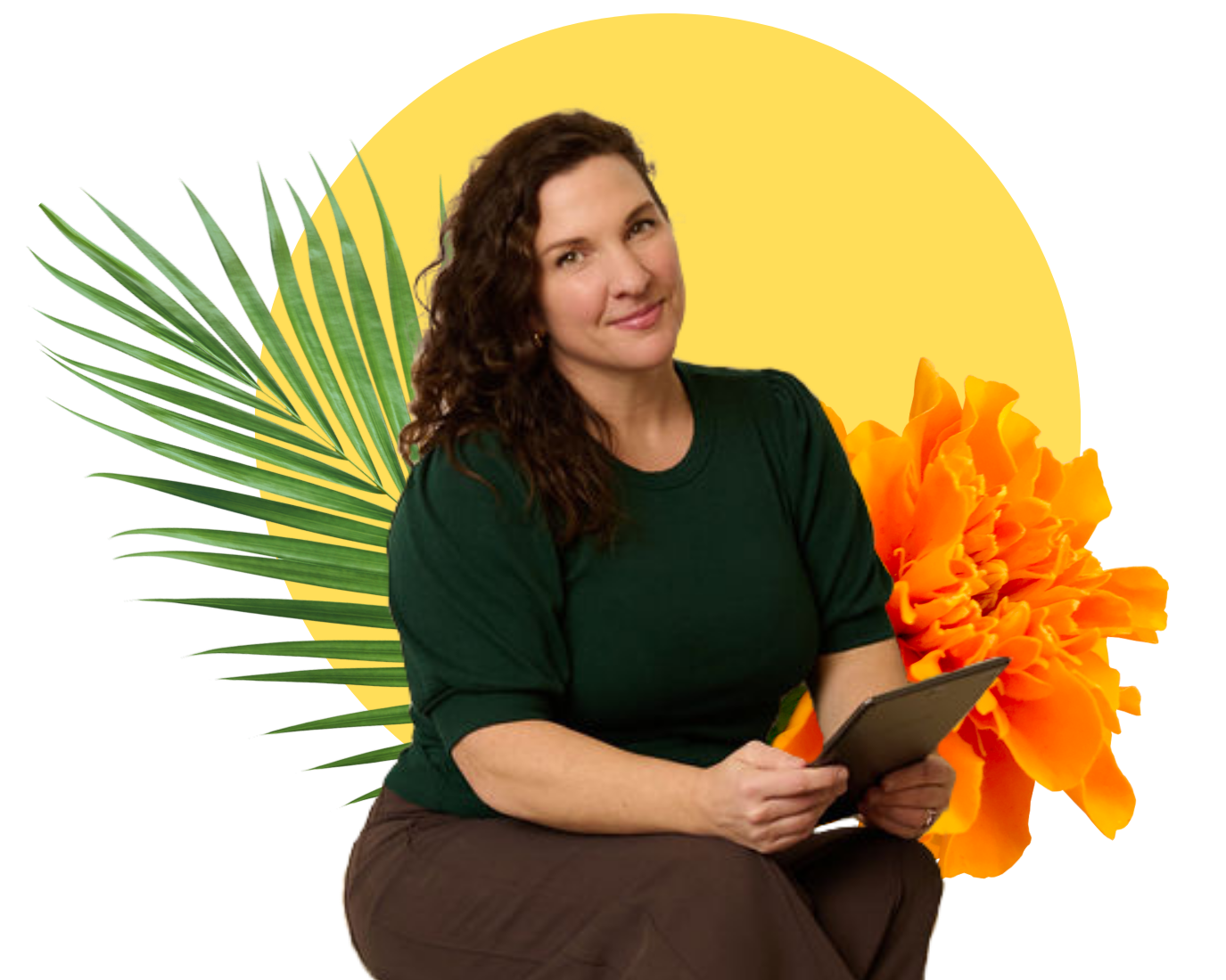 Devon with curly brown hair wearing a dark green shirt and brown pants, sitting and holding a tablet, with tropical leaves and an orange flower in the background.