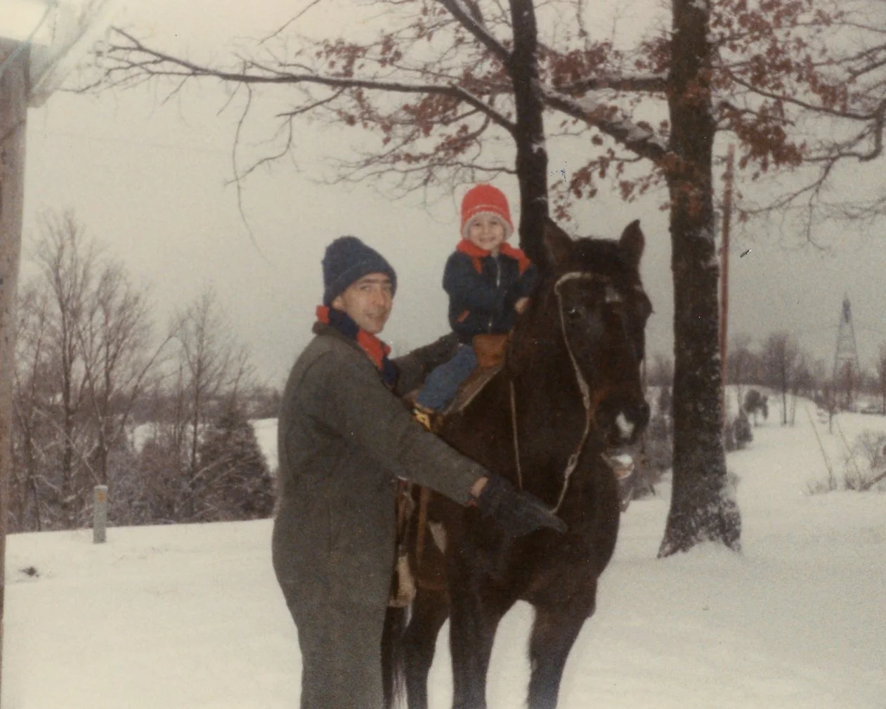 Snow and horses? What better way to celebrate a Kentucky winter?! ❄️🐎

Taken on his family farm in Grant County, these photos show Bill Petrie with Larry David, Gary Thomas, and Ribbon (the horse), c. 1984. Petrie is helping the two boys ride a hors