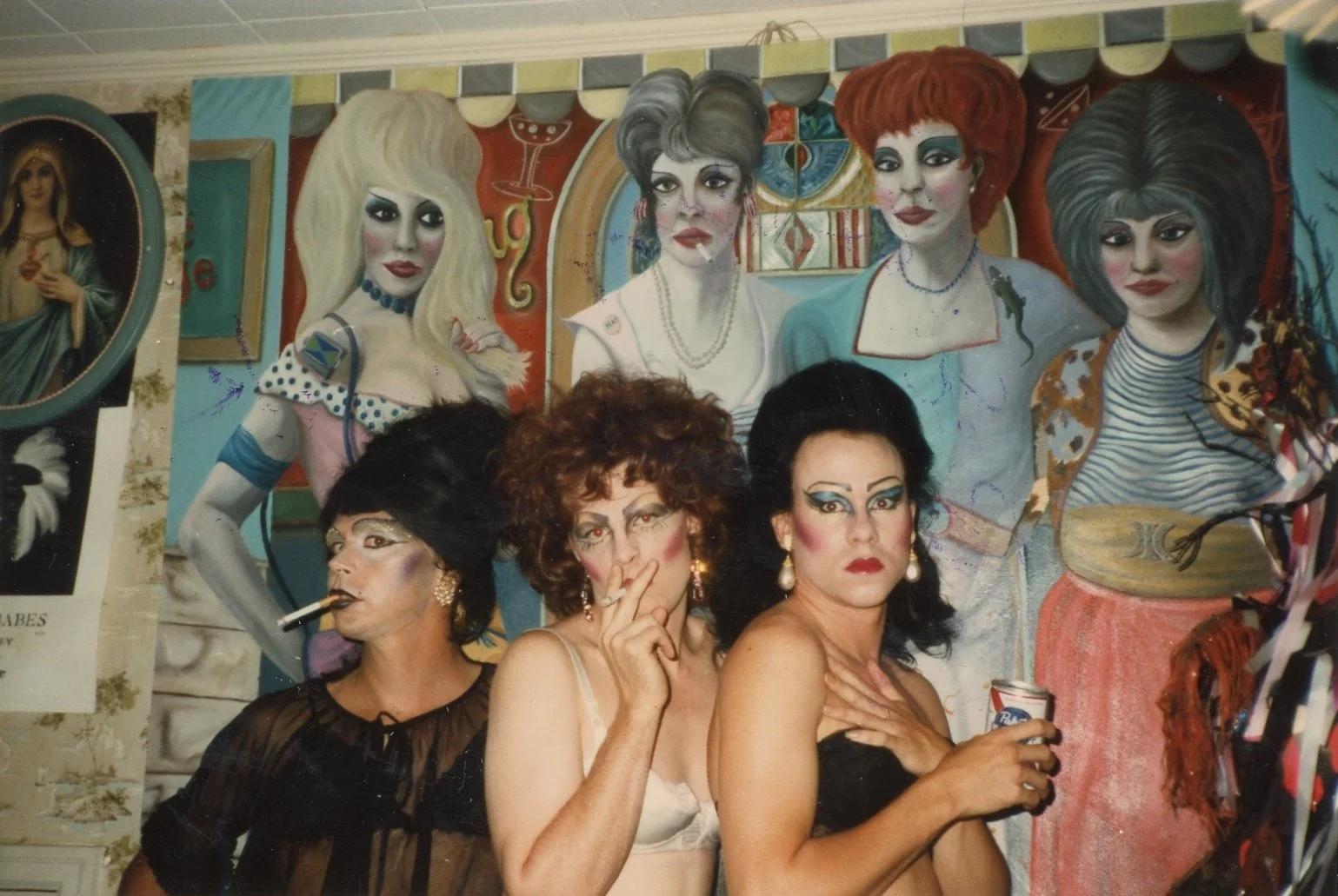 Don't mind us, just over here daydreaming about the weekend 🌈💭✨

📷: (L to R) Bob Morgan, Christina Serpentina Slone, and Bradley Picklesimer at Caf&eacute; LMNOP, in front of a mural painted by Jimmy Gordon, 1980s.
