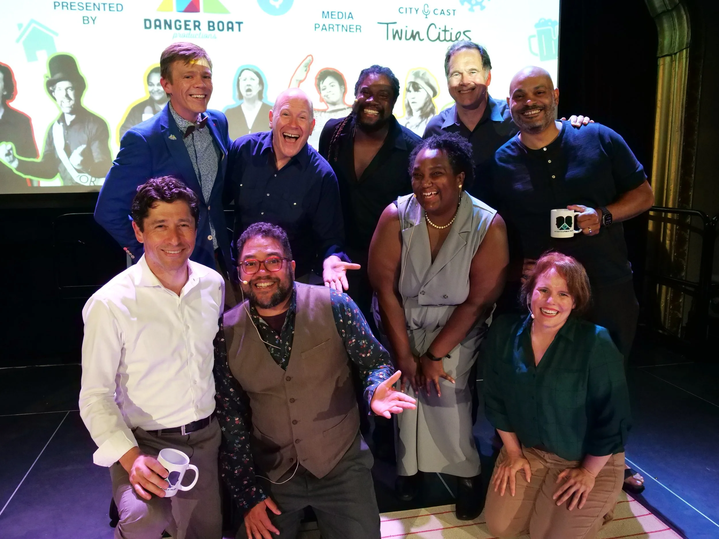  The host, guests, and cast pose for a picture onstage after the show. 