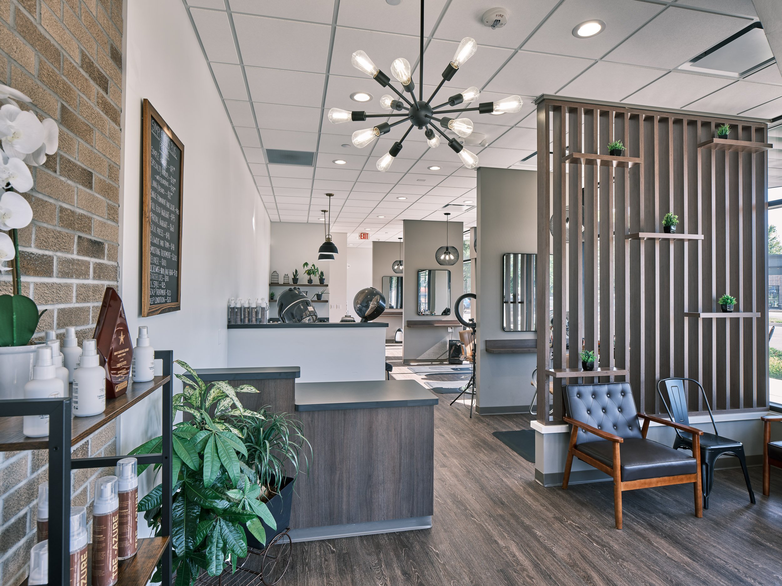 Reception space for a bright salon space with a modern slat wall divider. 