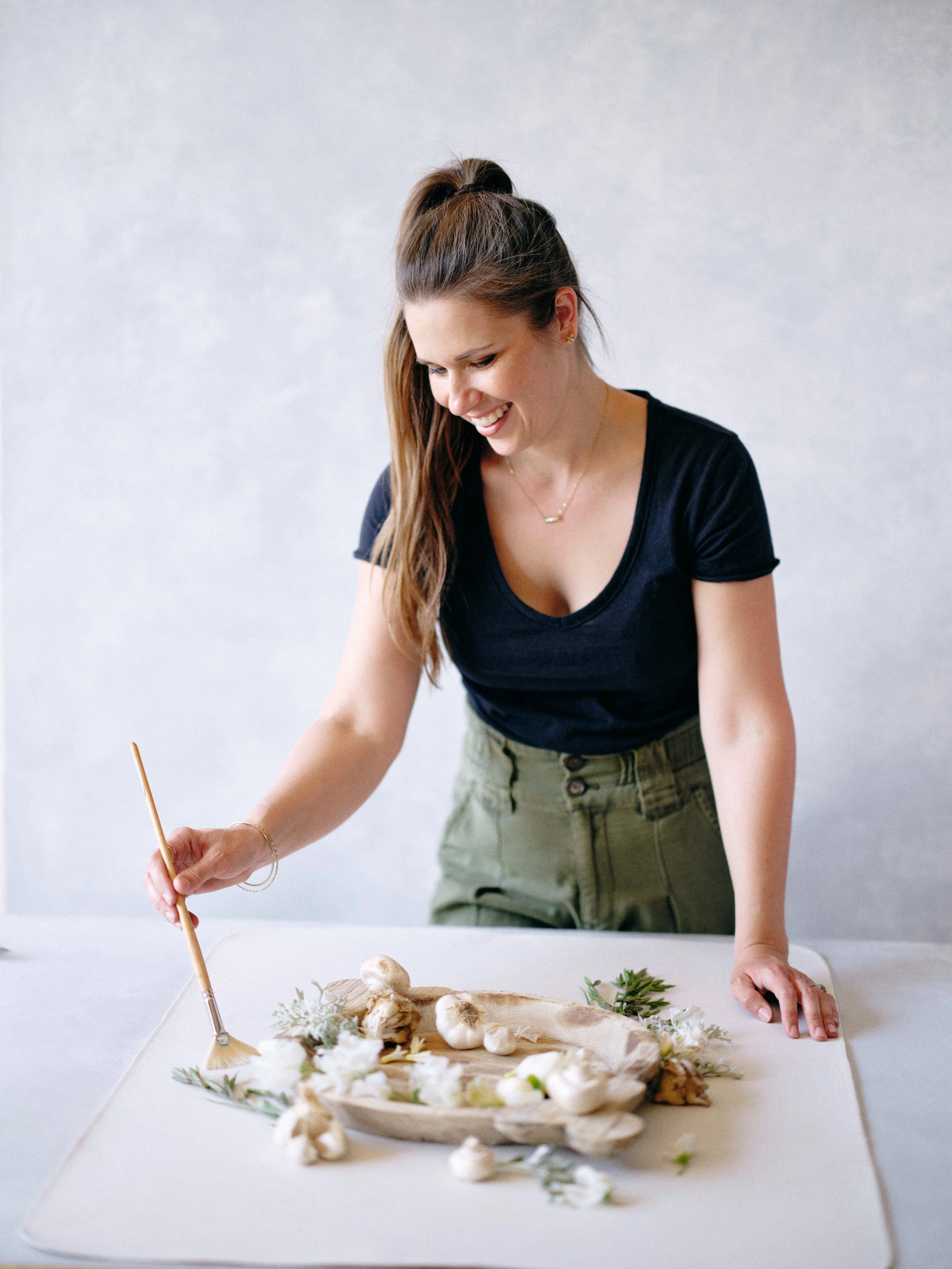 hand-painted canvas backdrop for flat lay photography styling showing professional creative process with neutral styling elements