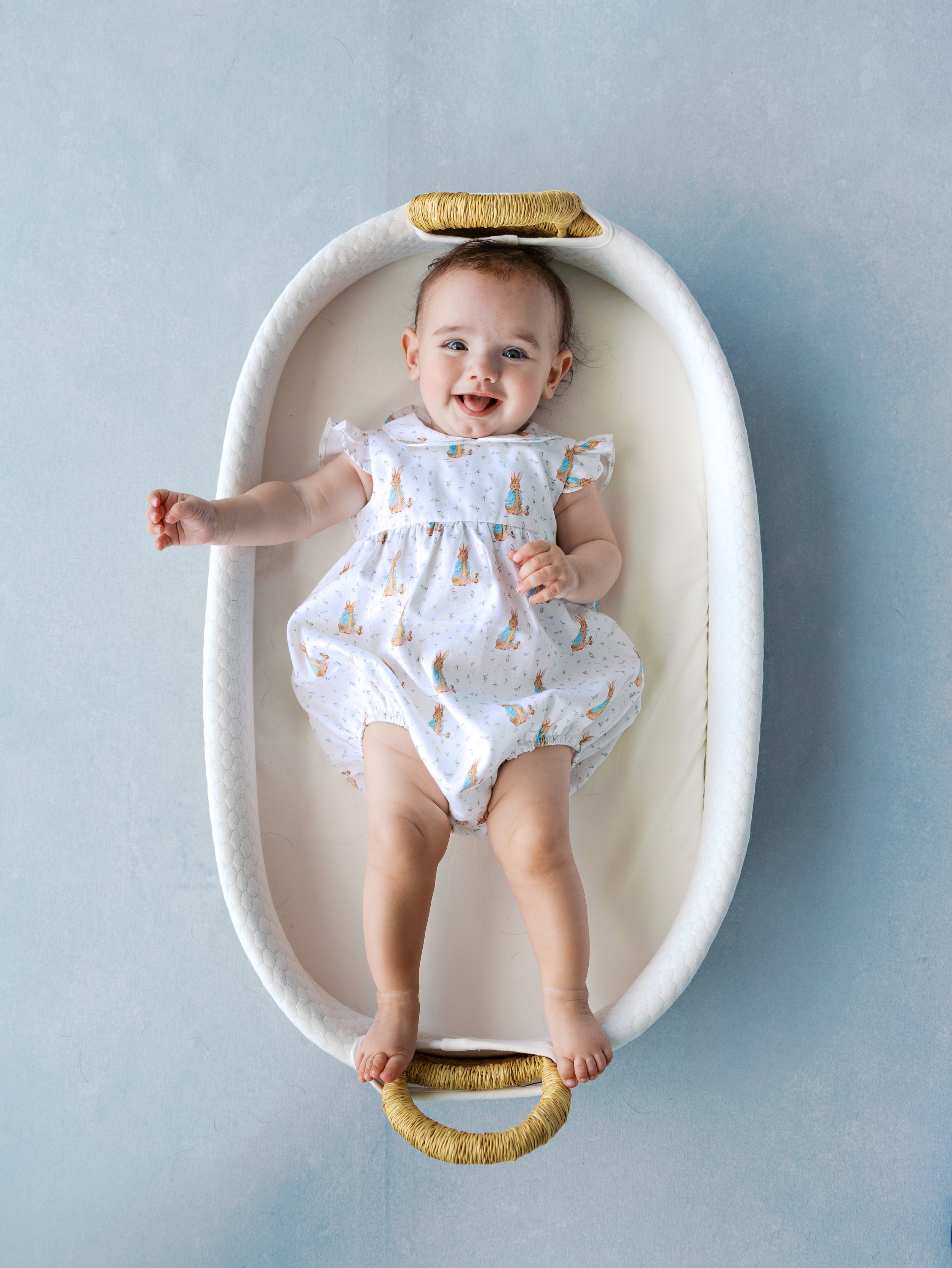 Fine art baby portrait in a wicker Moses basket on a Slate hand-painted canvas backdrop shot from overhead