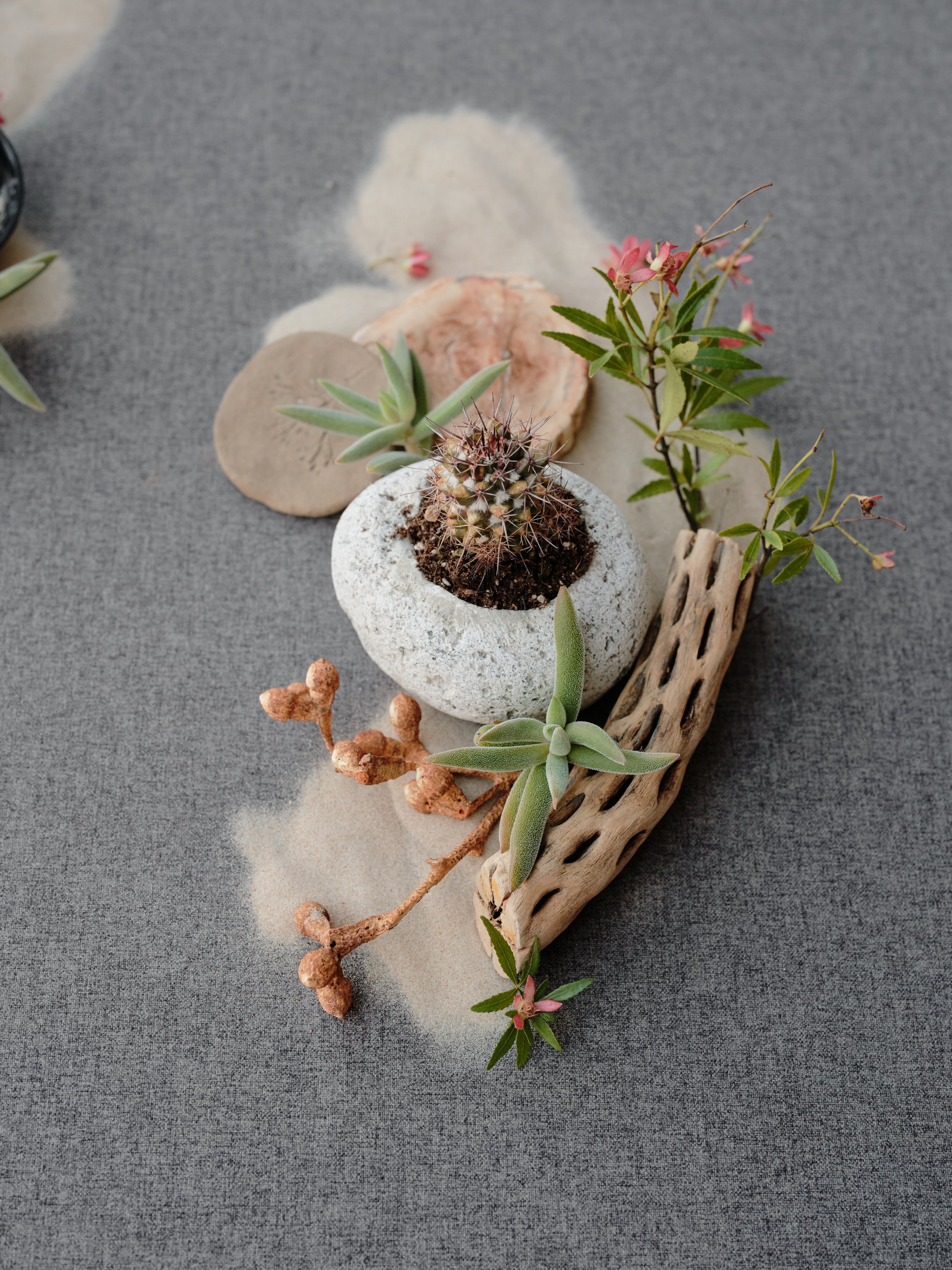 Diagonal flat lay composition demonstrating layering, negative space, and natural prop styling on a Chasing Stone hand-painted surface