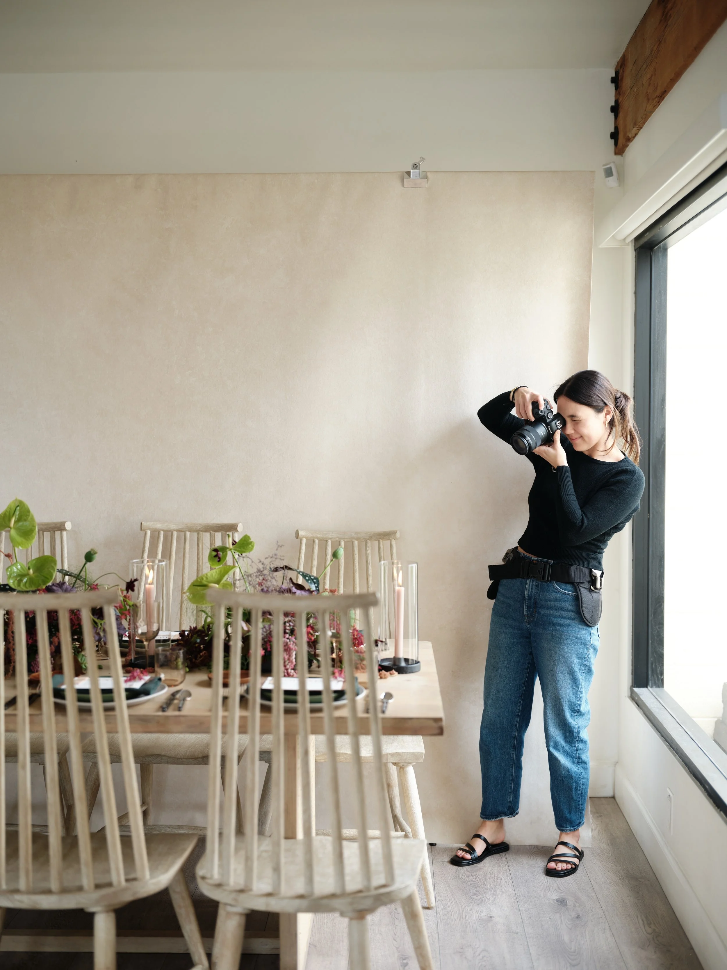 professional portrait photographer shooting with BENTONITE neutral canvas backdrop in natural light studio setup