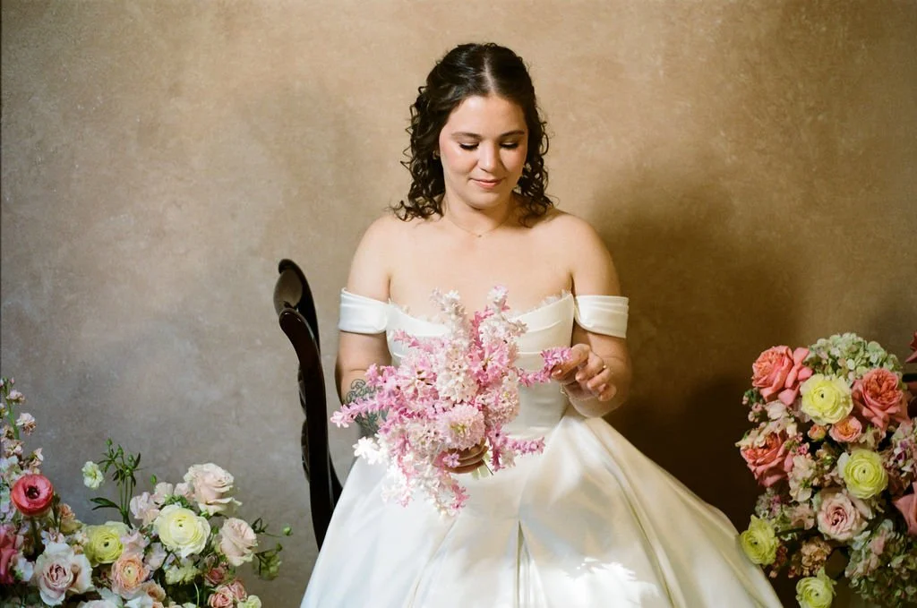 bride holding pink floral bouquet in studio portrait with neutral backdrop, example of 8x10 photography backdrop size