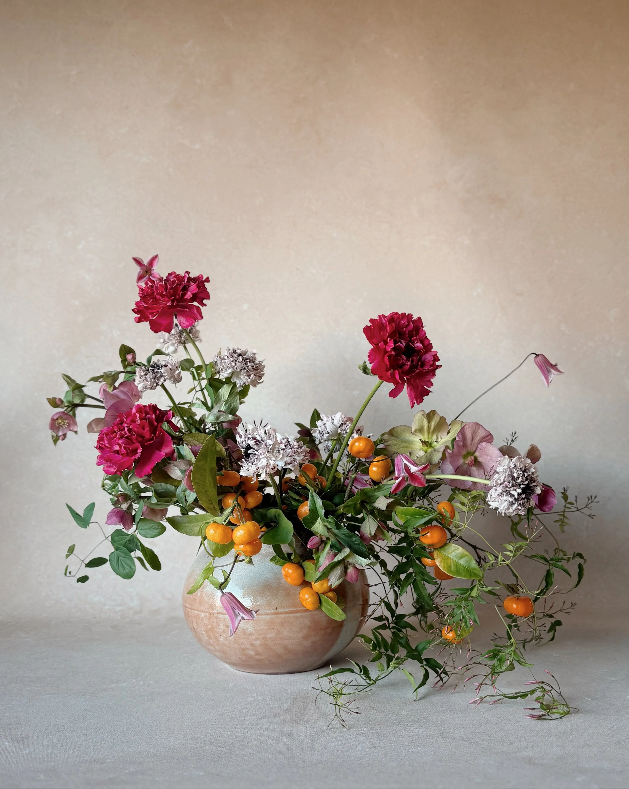 editorial floral arrangement against Chasing Stone Sandstone hand-painted canvas backdrop