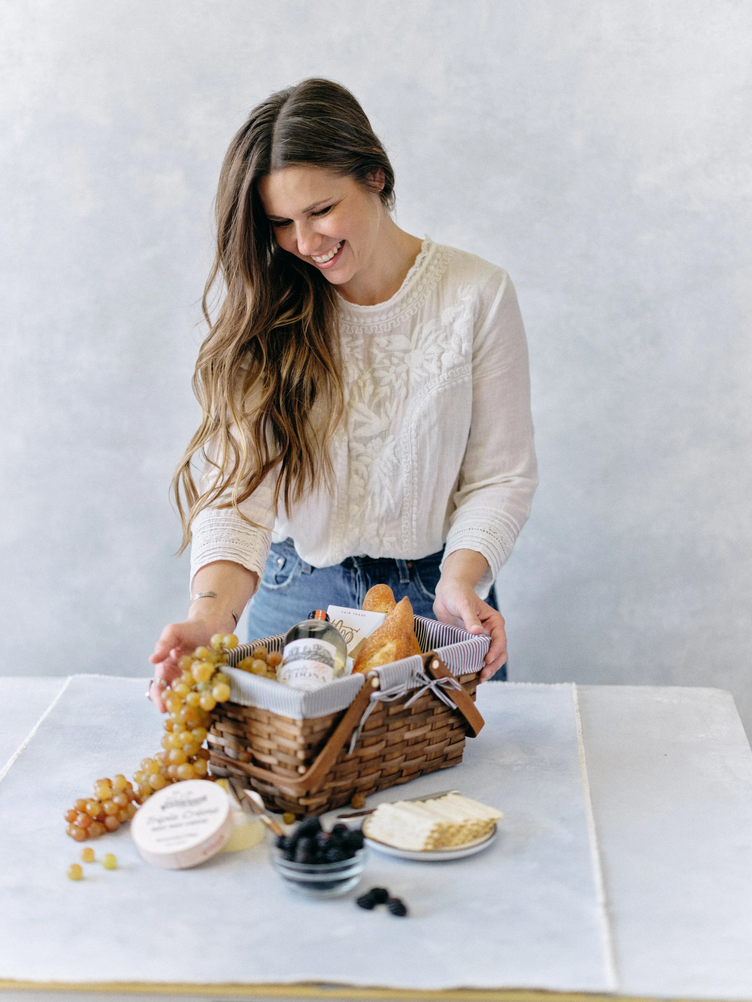 Photographer preparing a spring wedding backdrop kit with hand-painted canvas and styling surface