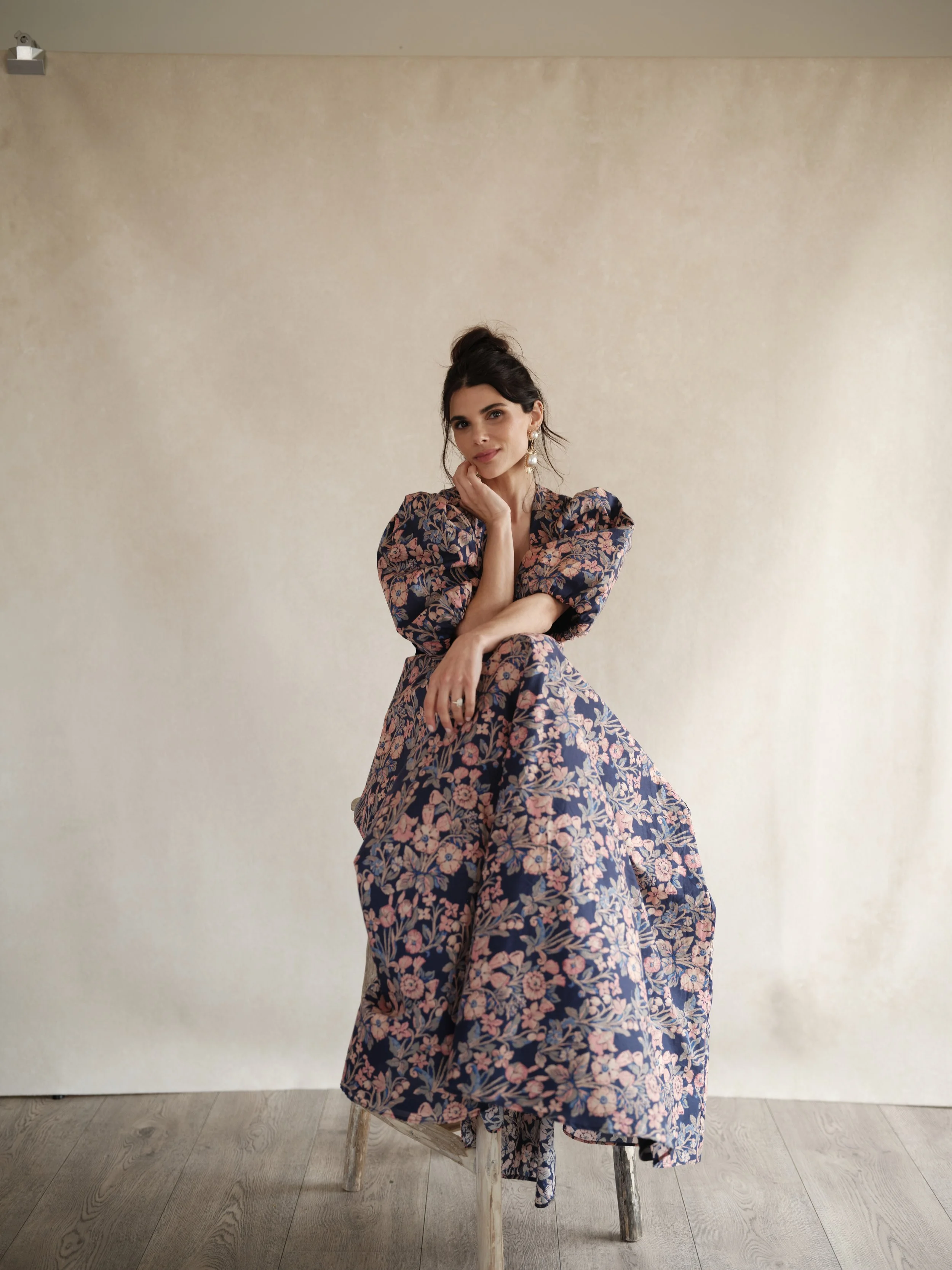 full-length senior portrait photography example showing neutral canvas backdrop with bold floral wardrobe choice