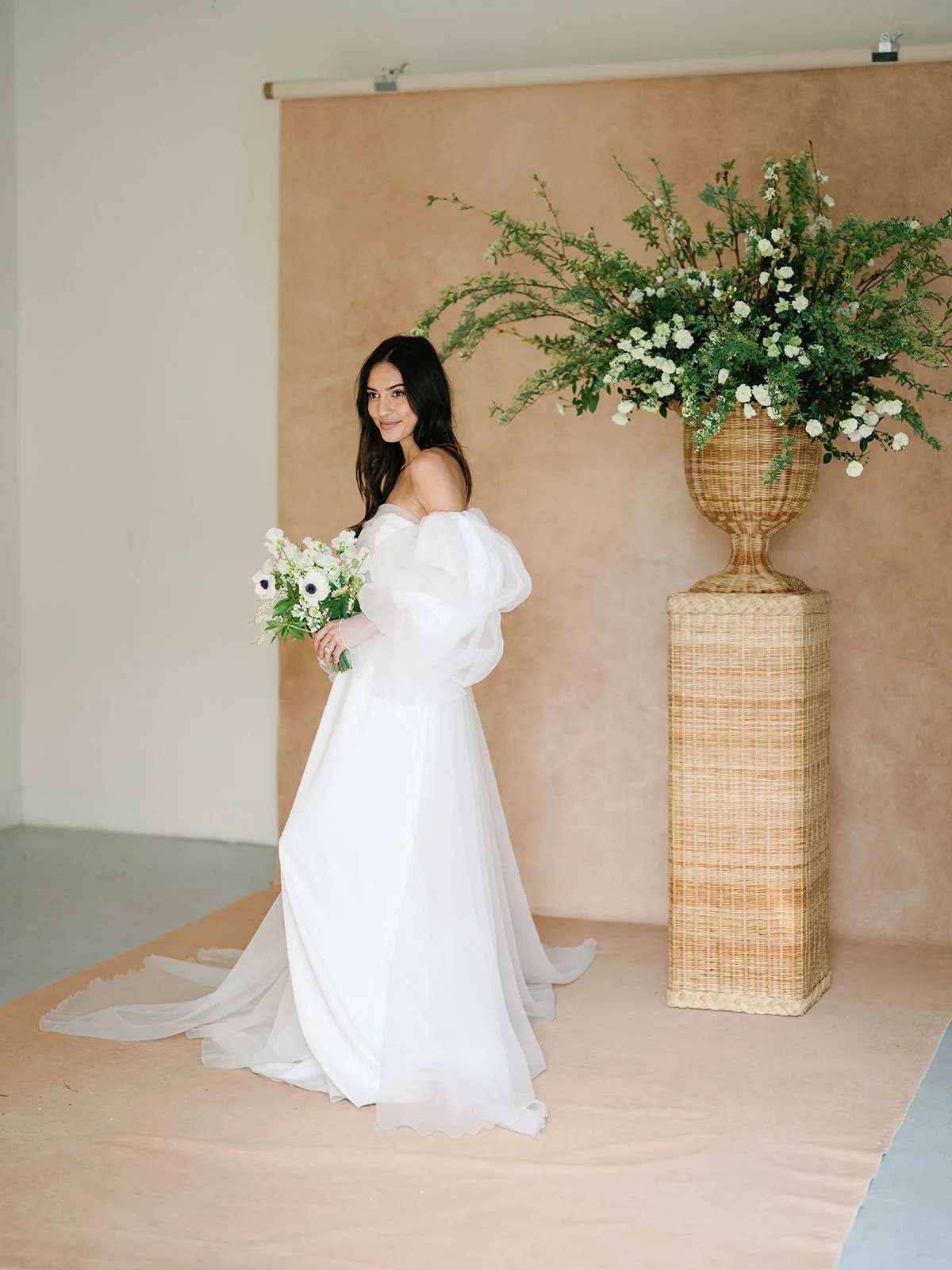 bridal portrait on a Clay hand-painted canvas backdrop, matching Pantone's Muted Clay autumn 2026 trend color