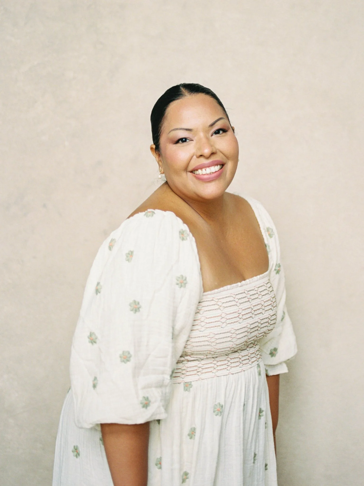 portrait of woman posing naturally in front of a neutral hand-painted photography backdrop