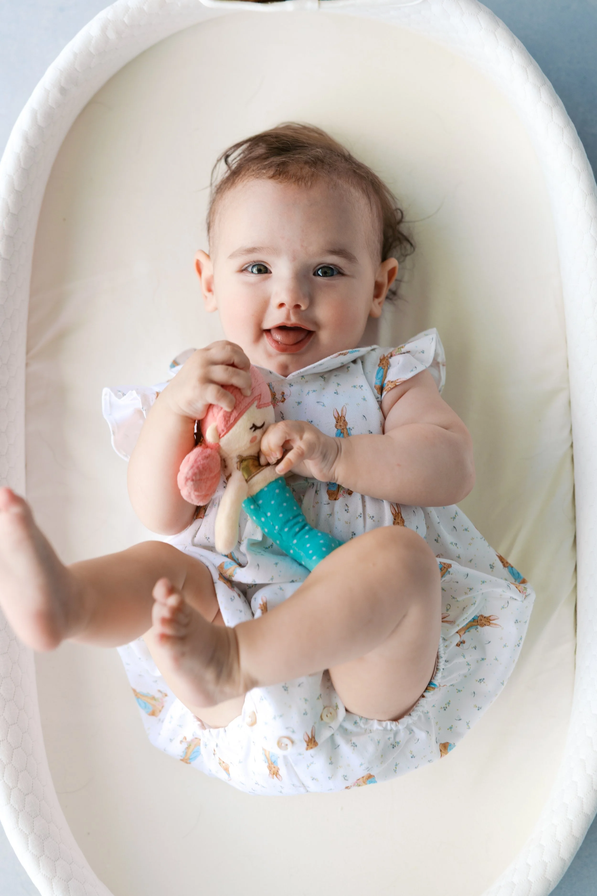 Natural light baby portrait photographed in a small home studio using a hand-painted photography backdrop