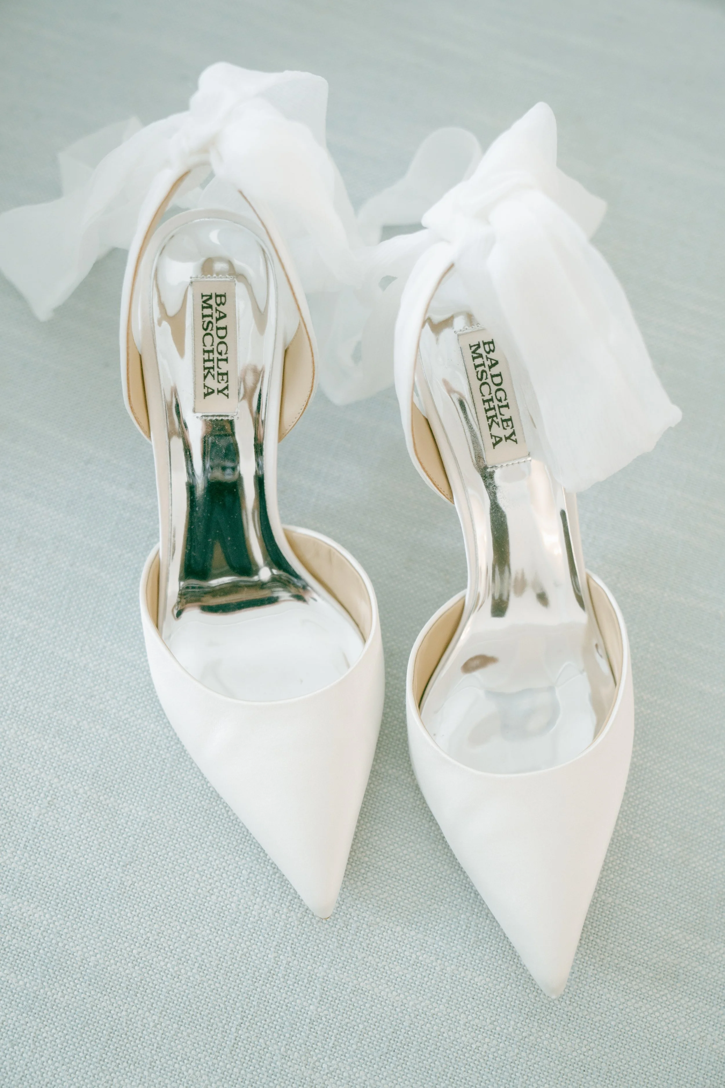 bridal shoes photographed on a textured hand-painted photography backdrop for a wedding detail shot