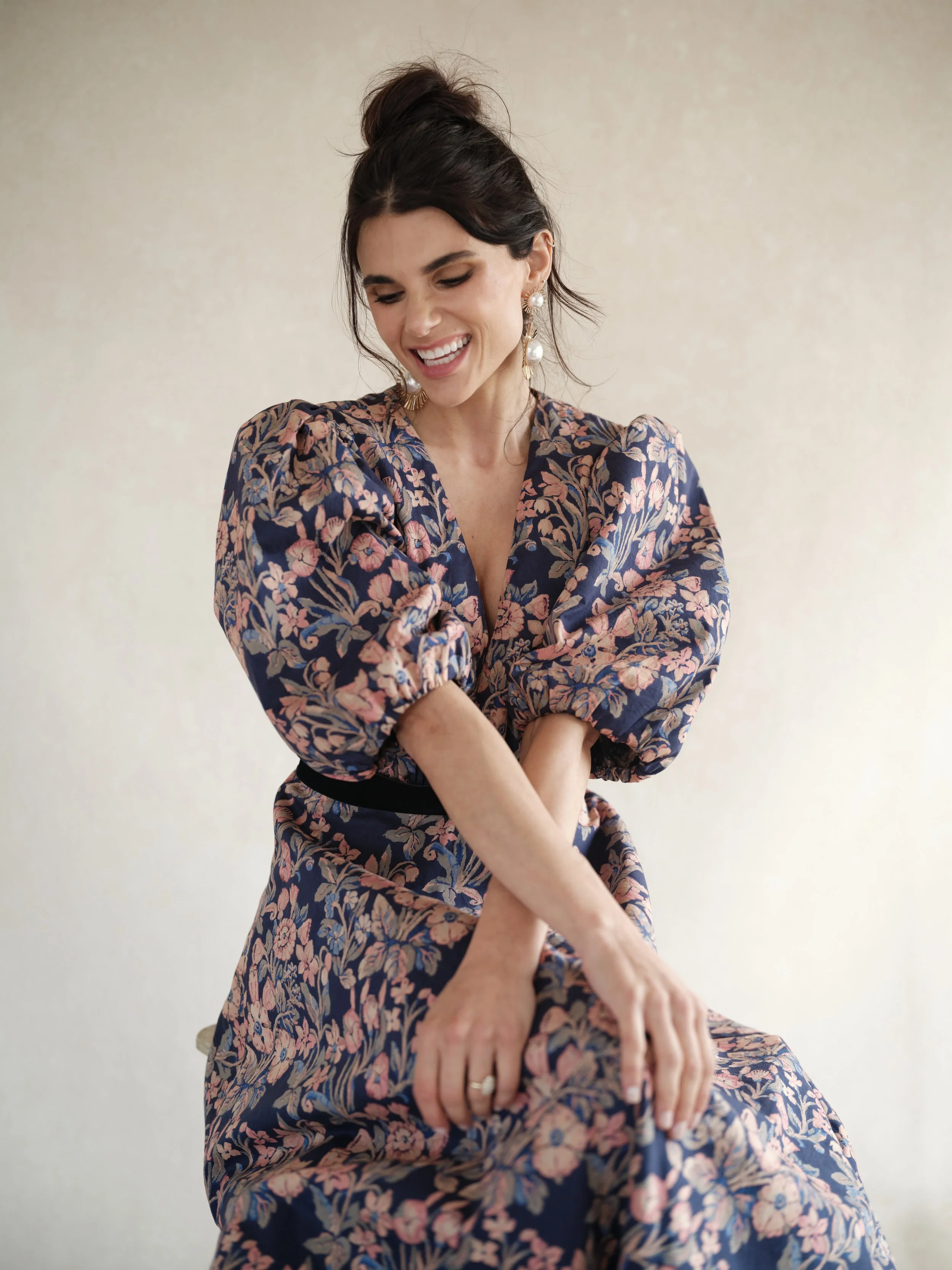 Editorial portrait demonstrating how a warm taupe hand-painted backdrop enhances fair skin with golden undertones without color spill