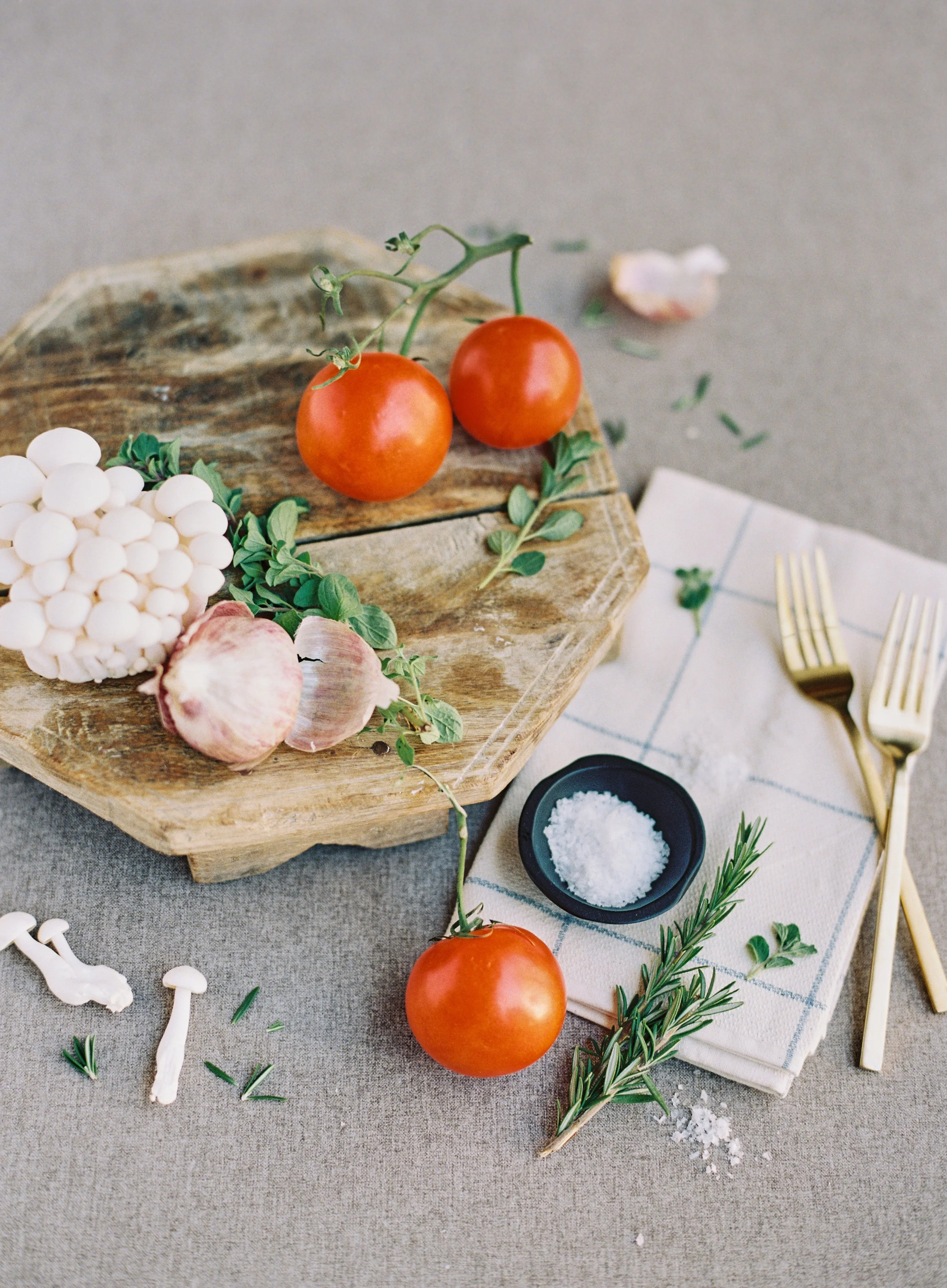 Editorial flat lay styling with vegetables and utensils on hand-painted photography backdrop