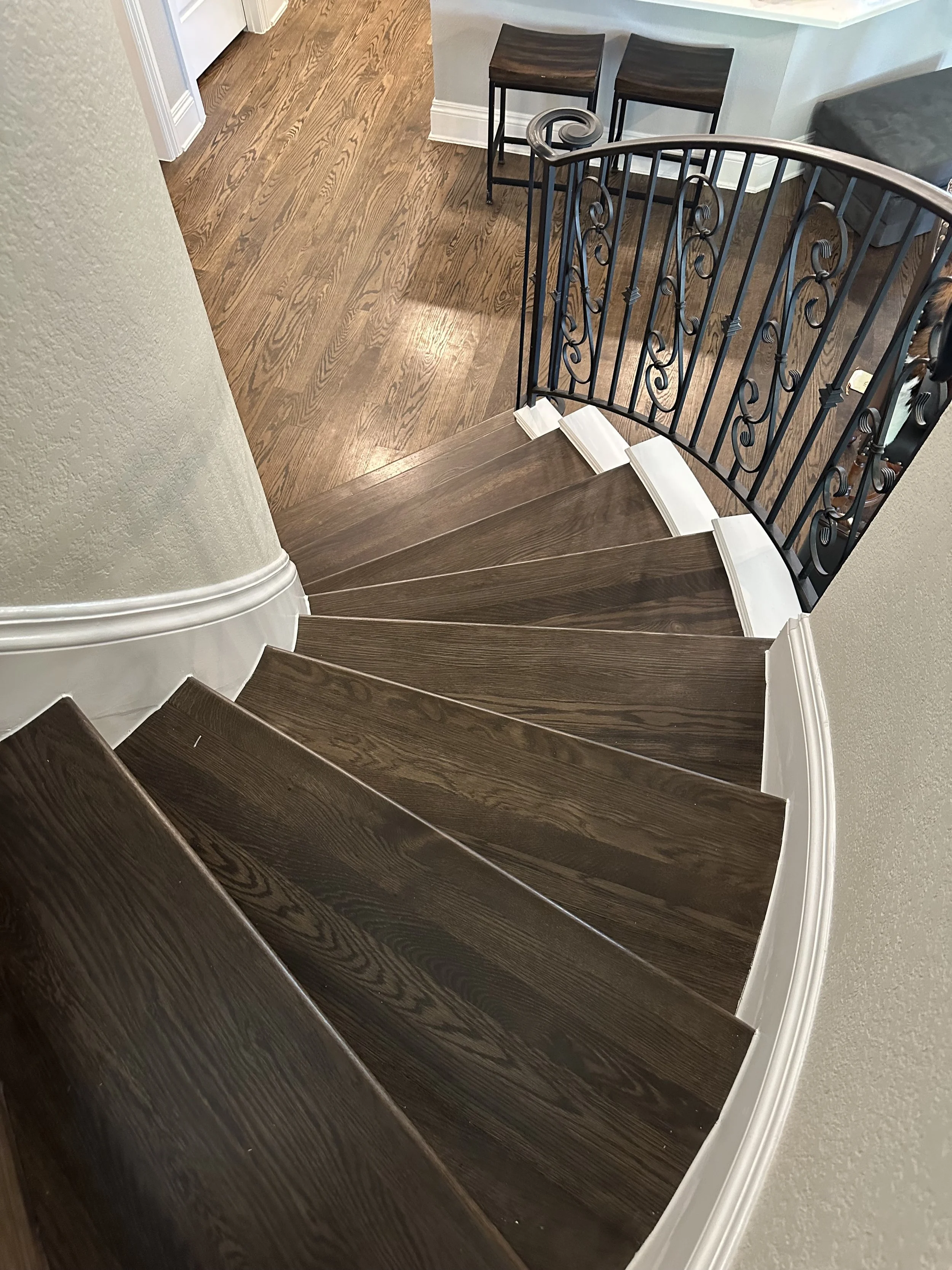 Solid W/O treads stained and finished to match flooring throughout house.