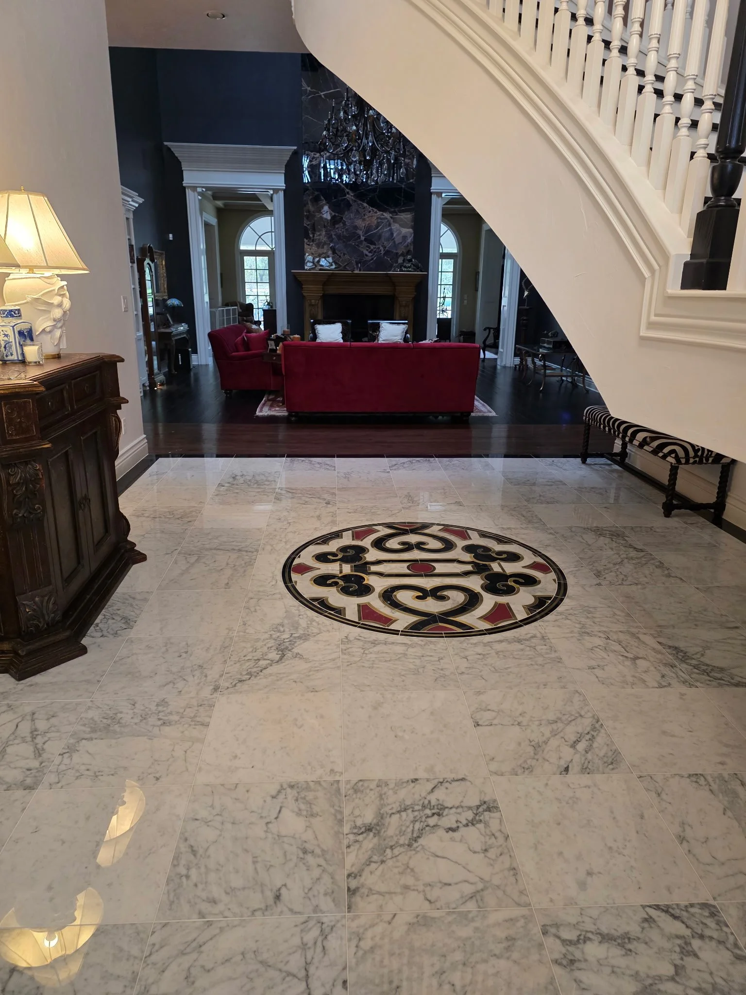 18x18 Carrera Polished Marble with custom Medallion Inlay and black border.