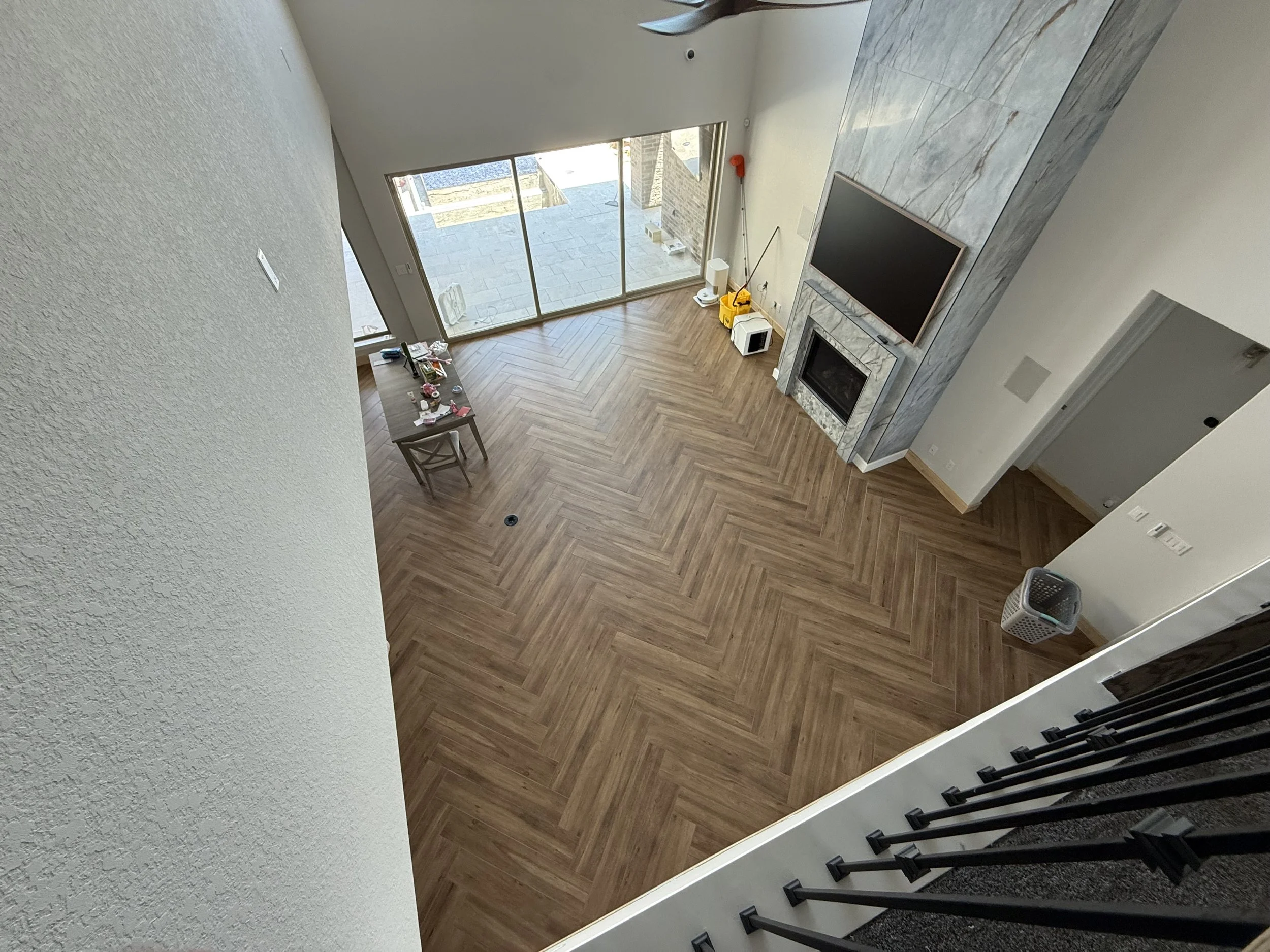 Porcelain tile planks SS Mattina laid in a Herringbone design with re-constructed staircase solid treads.