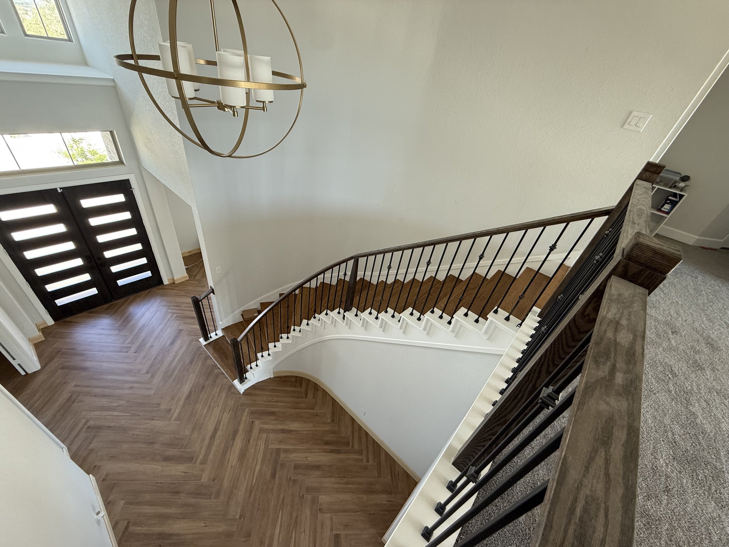 Porcelain tile planks laid in a Herringbone design with re-constructed staircase solid treads.
