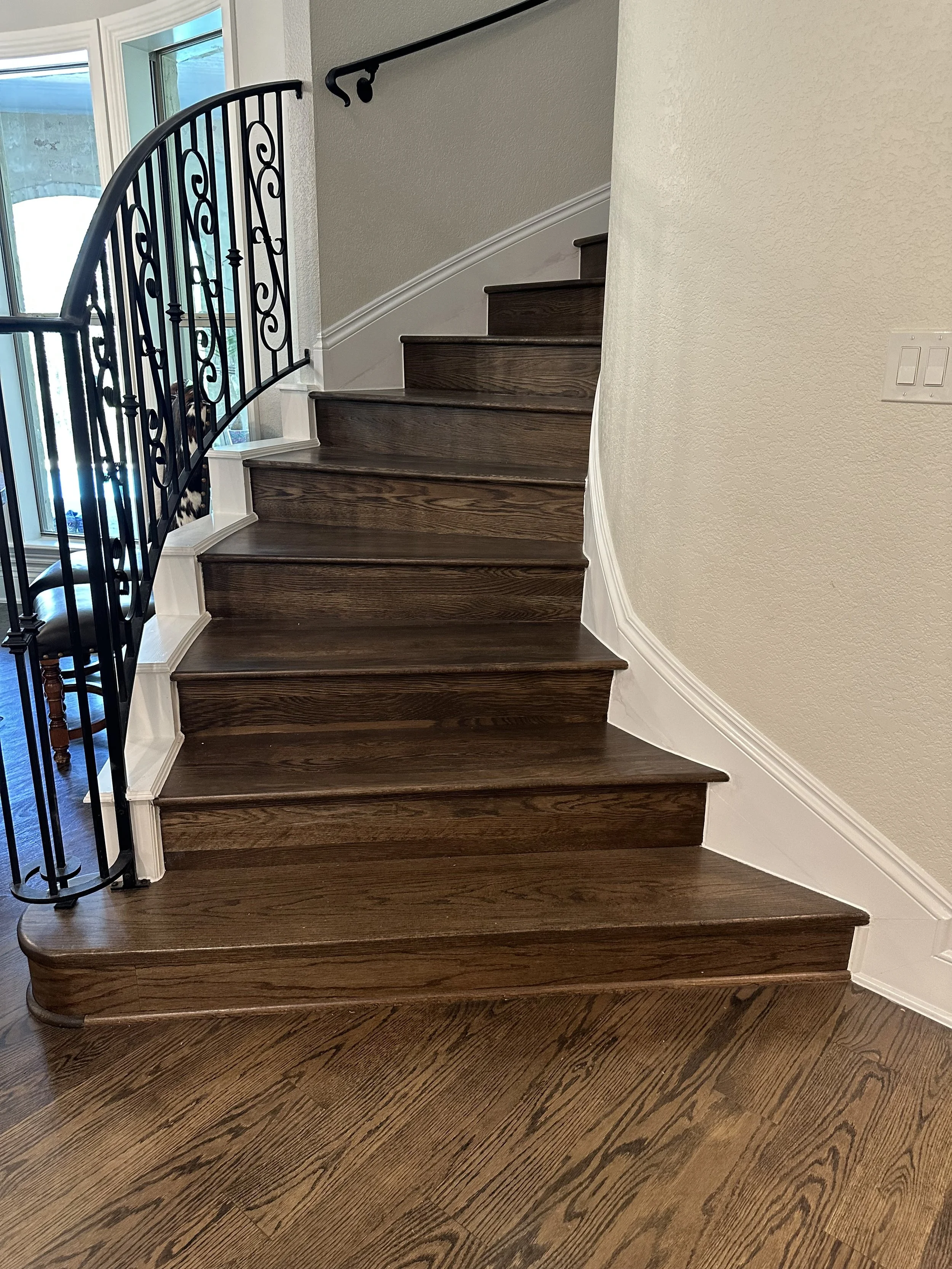 Solid W/O treads stained and finished to match flooring throughout house.