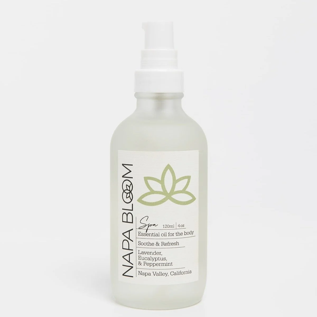 Napa Bloom Spa Body Oil in a 4 oz frosted glass bottle with white pump and ivory label featuring a green lotus design — eucalyptus, peppermint, and lavender blend.