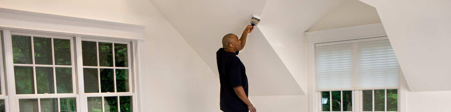 interior painter rolling paint on drywall wall in Elkhart County home