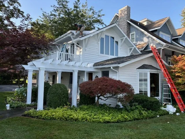 Painter working on exterior home details to ensure lasting protection against the weather