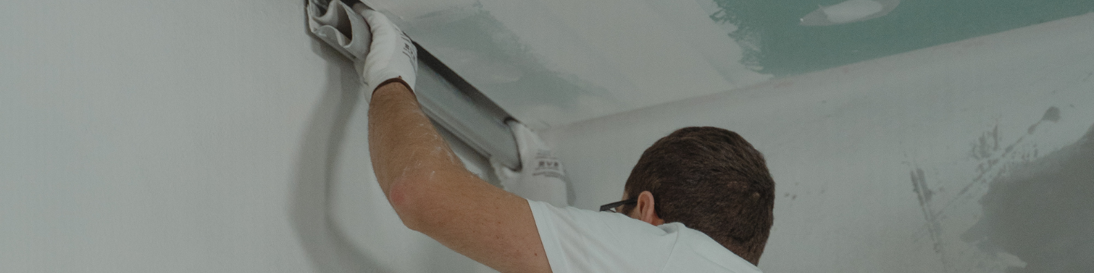 Professional drywall contractor working on an interior wall