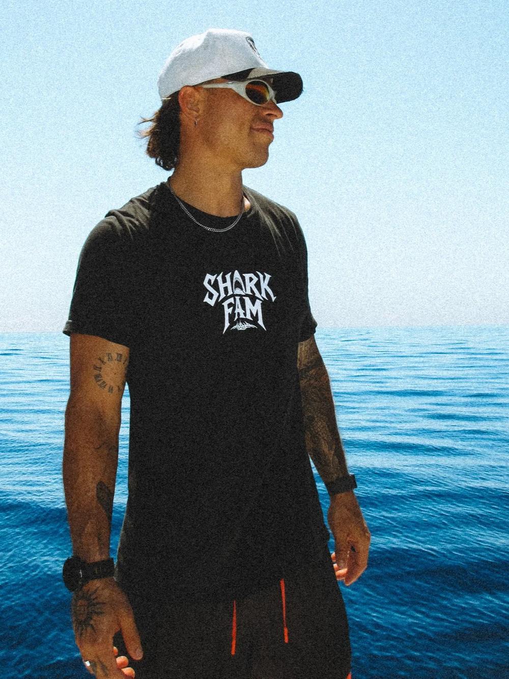 Tanner Mansell aboard a boat, wearing a Shark Fam shirt